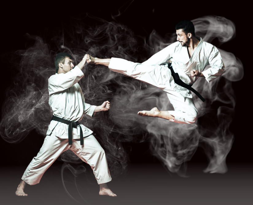 Two men are practicing karate and one is kicking the other in the air
