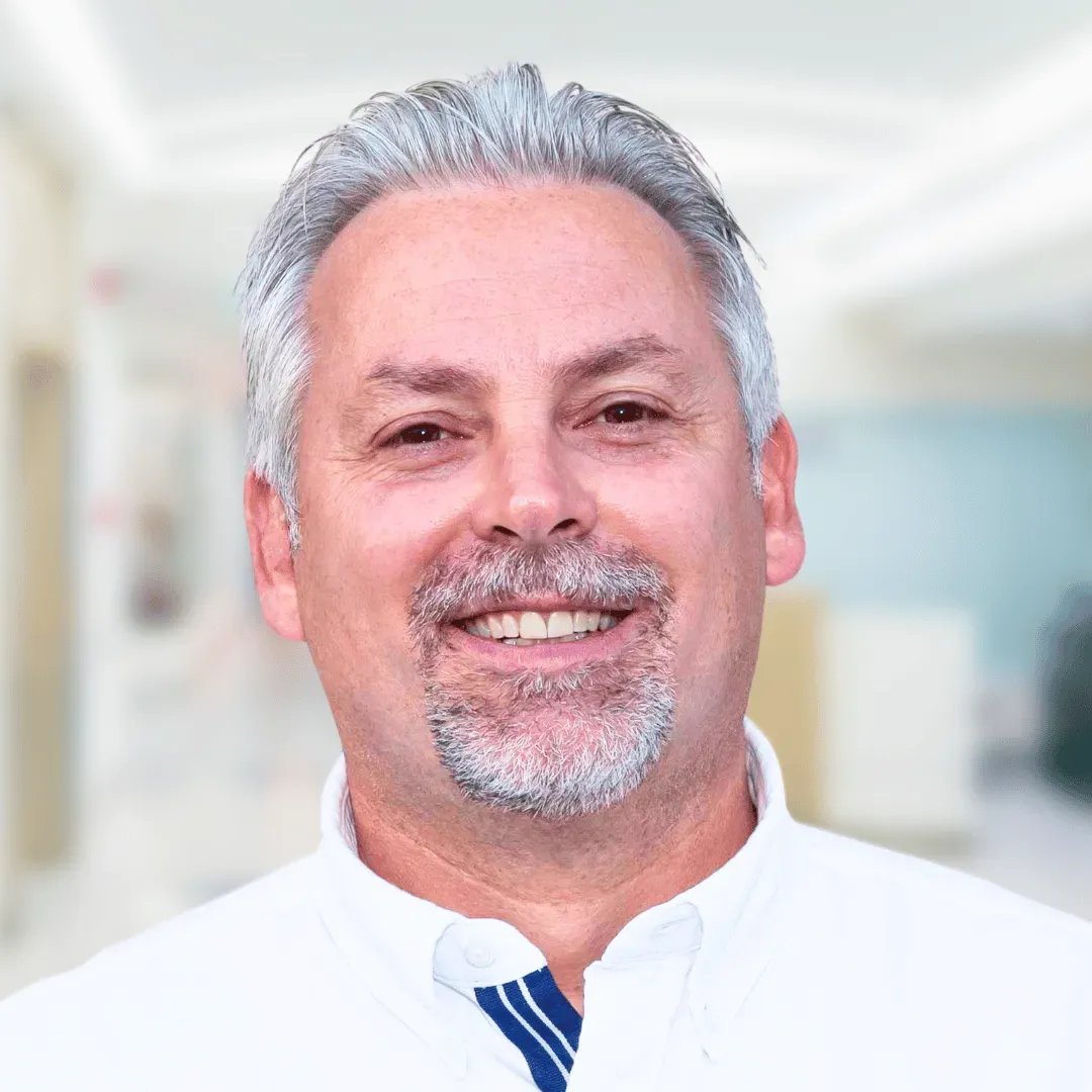 Dr. Glen Mccracken headshot
A white man with a grey beard wearing a white shirt and tie.