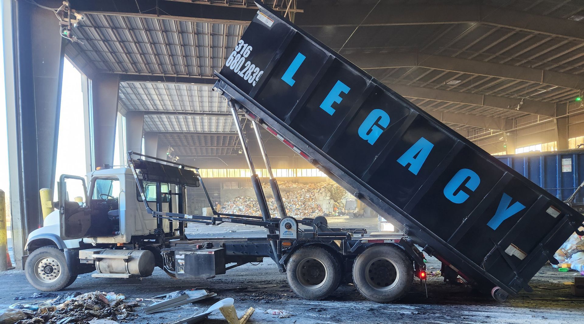 A dump truck with the word legacy on the side of it