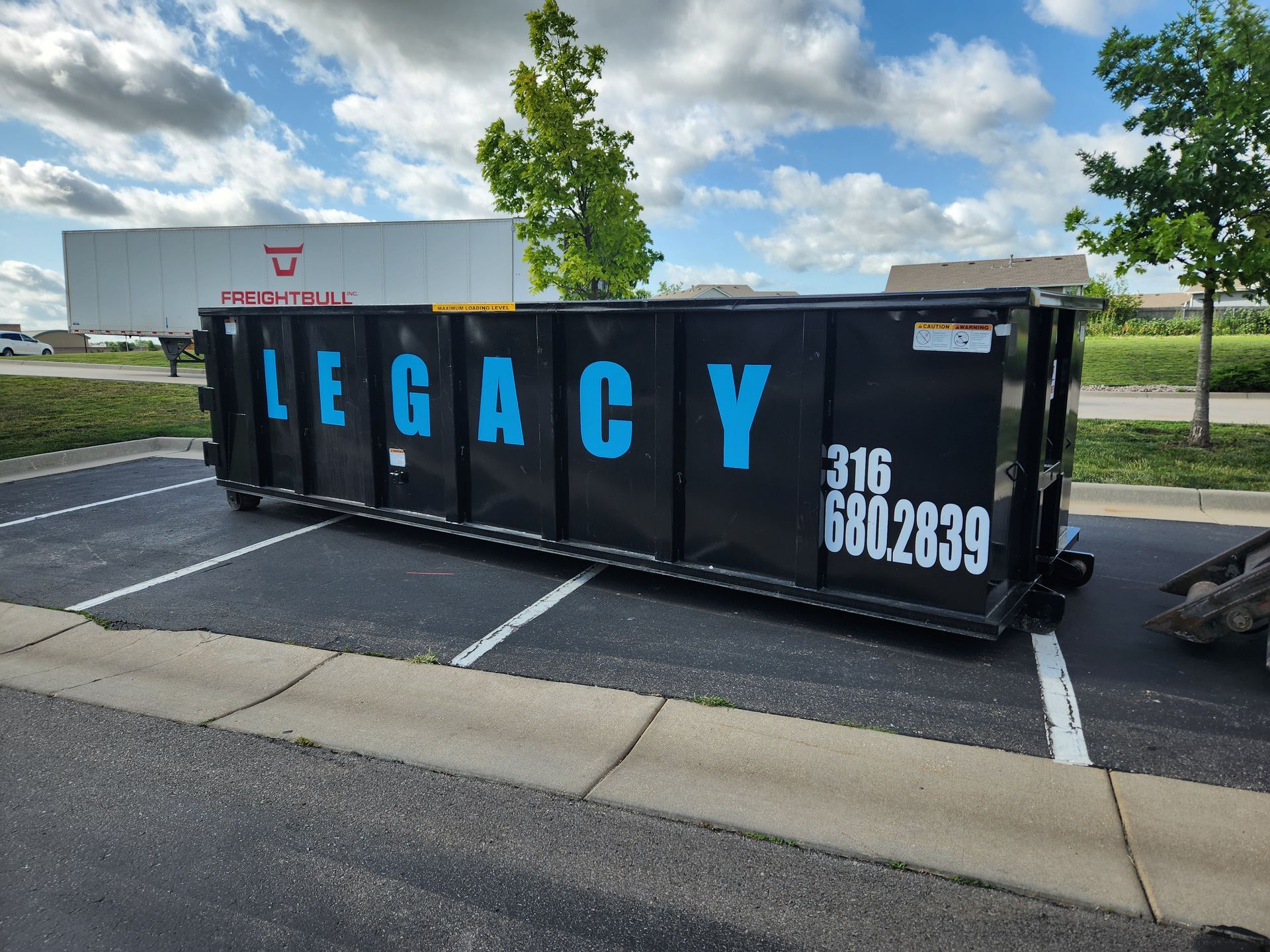 A dumpster with the word legacy on it