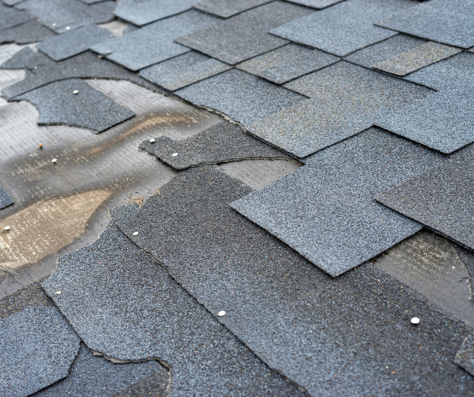 A close up of a roof with a lot of shingles missing.