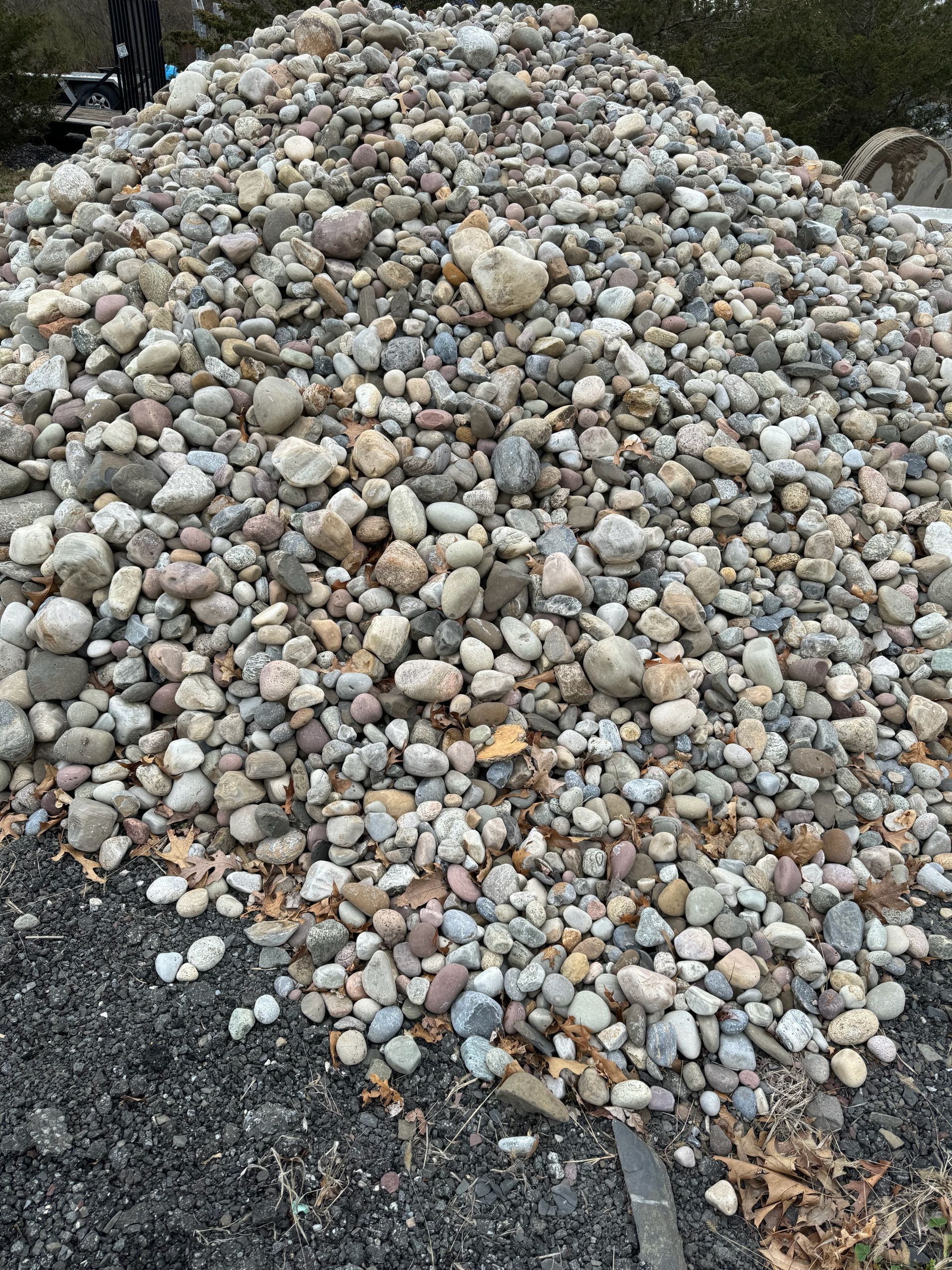 A pile of rocks is sitting on top of a pile of dirt.