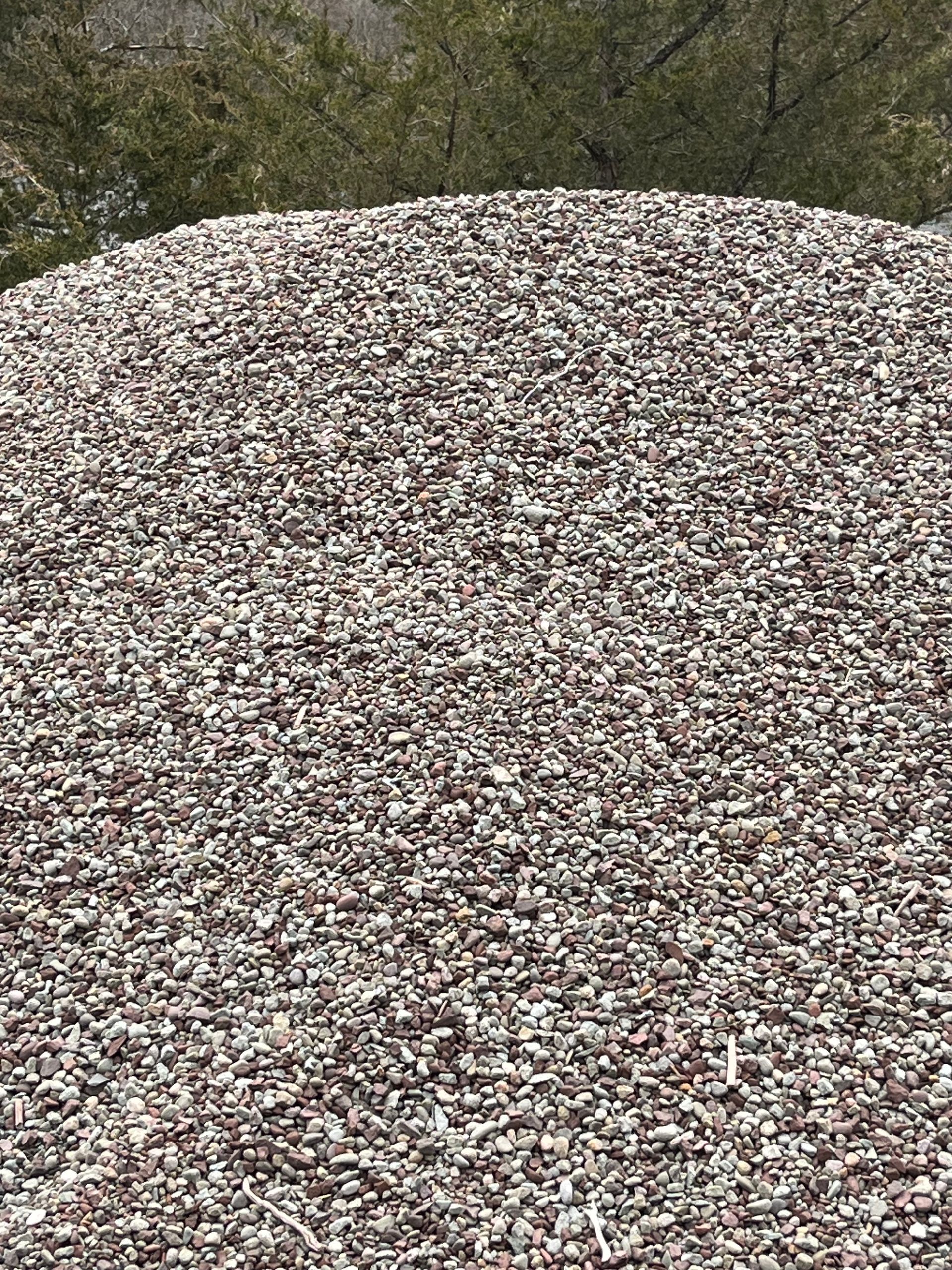 A pile of gravel is sitting on top of a hill.