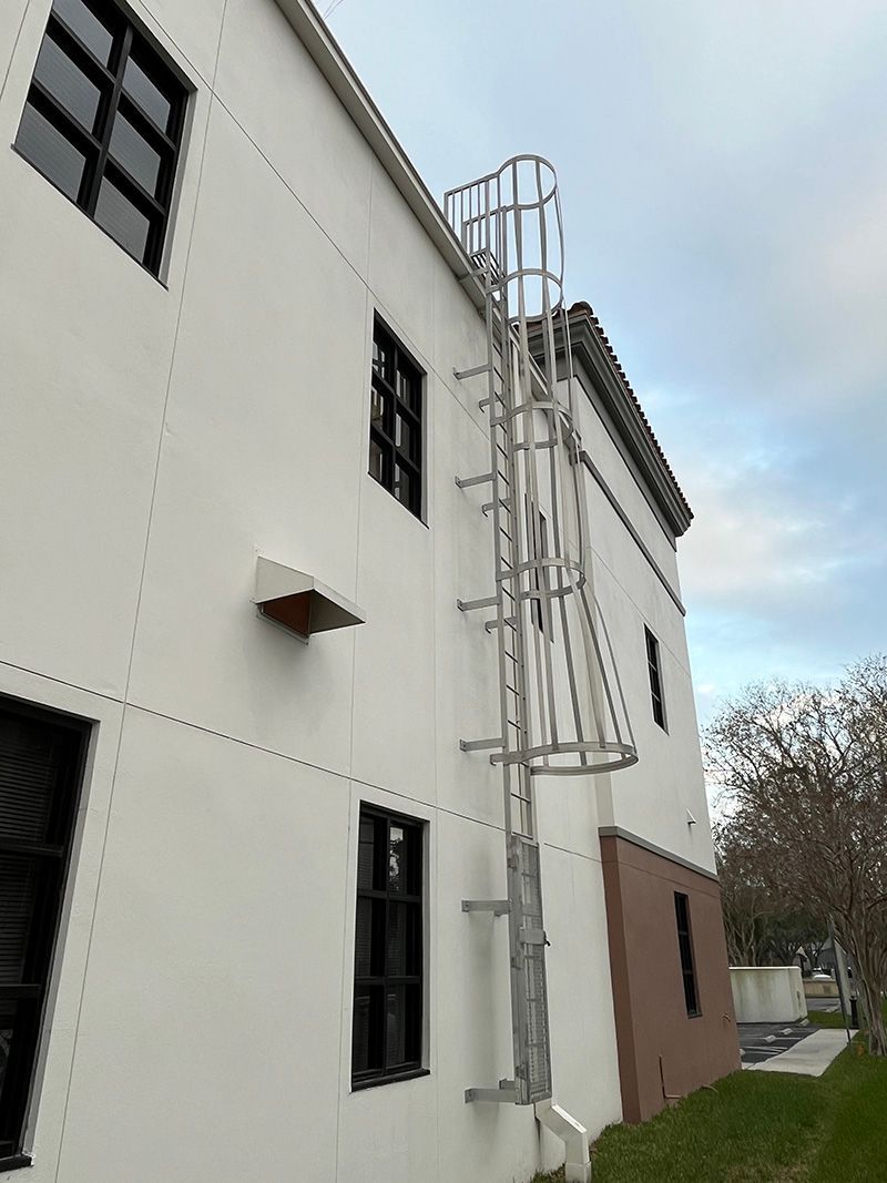 ladder bolted to the side of a building allowing roof access