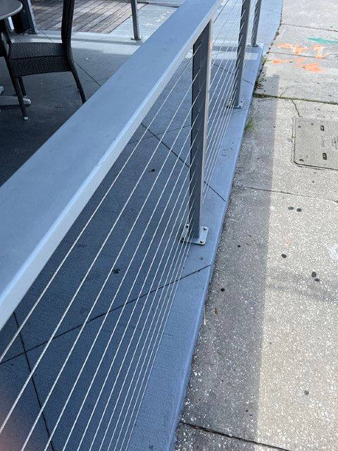 Bench and table with cable railing in an outdoor setting