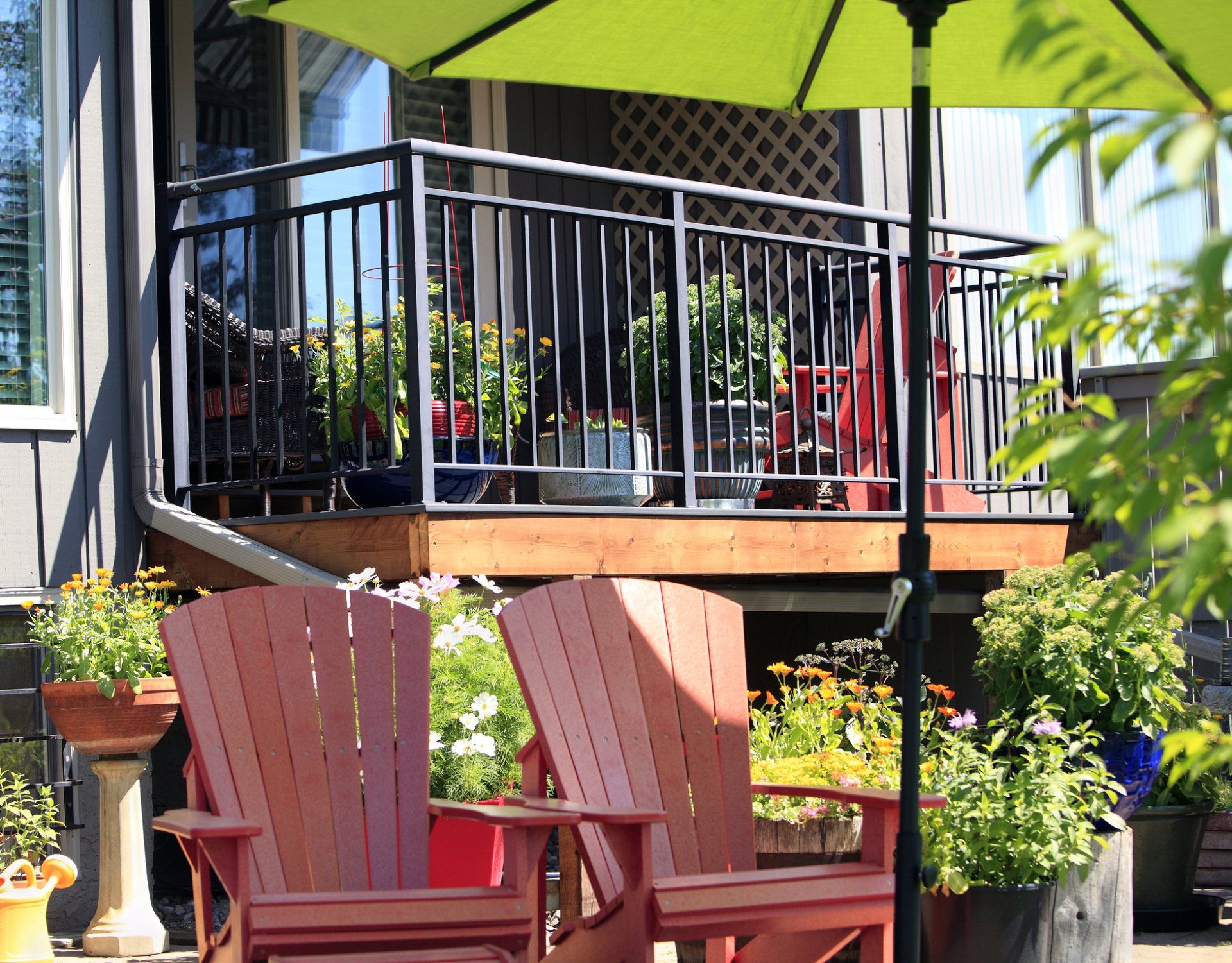 Elevated wooden deck in South Tampa backyard with metal railing, part of the surrounding fence