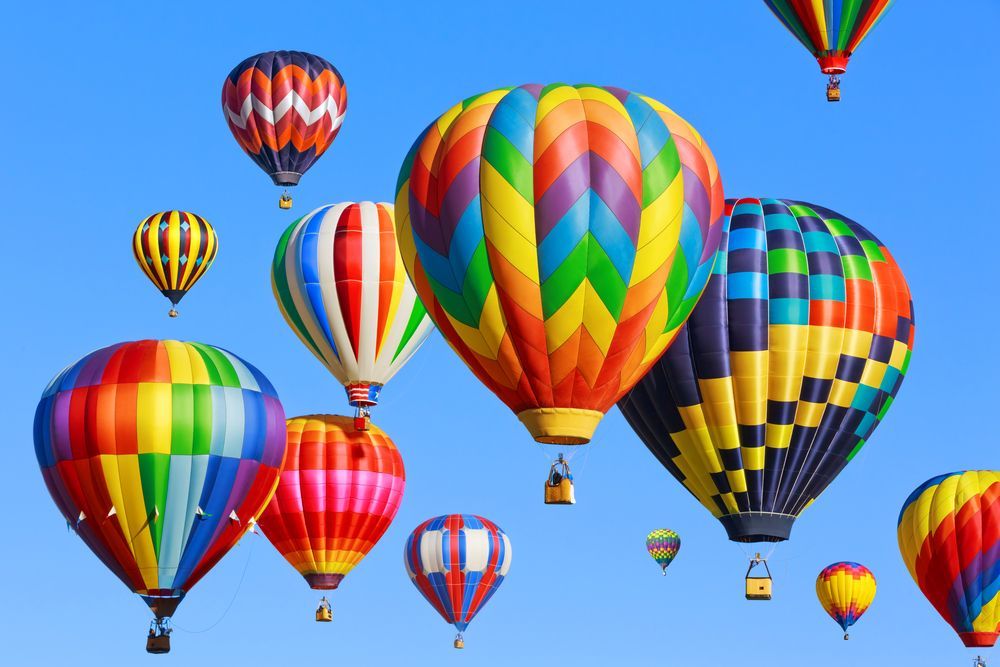 Colorful hot air balloons floating in a clear blue sky