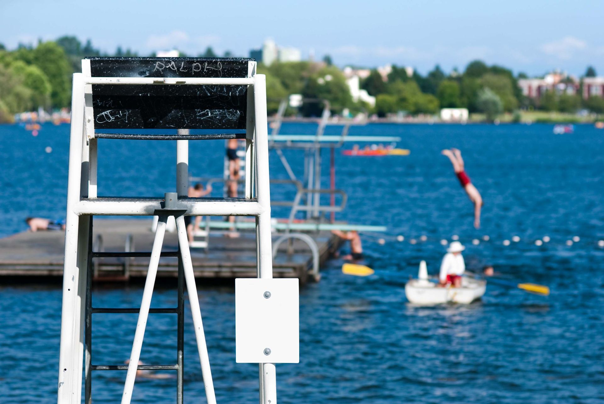 A lifeguard stands on a dock overlooking a body of water.