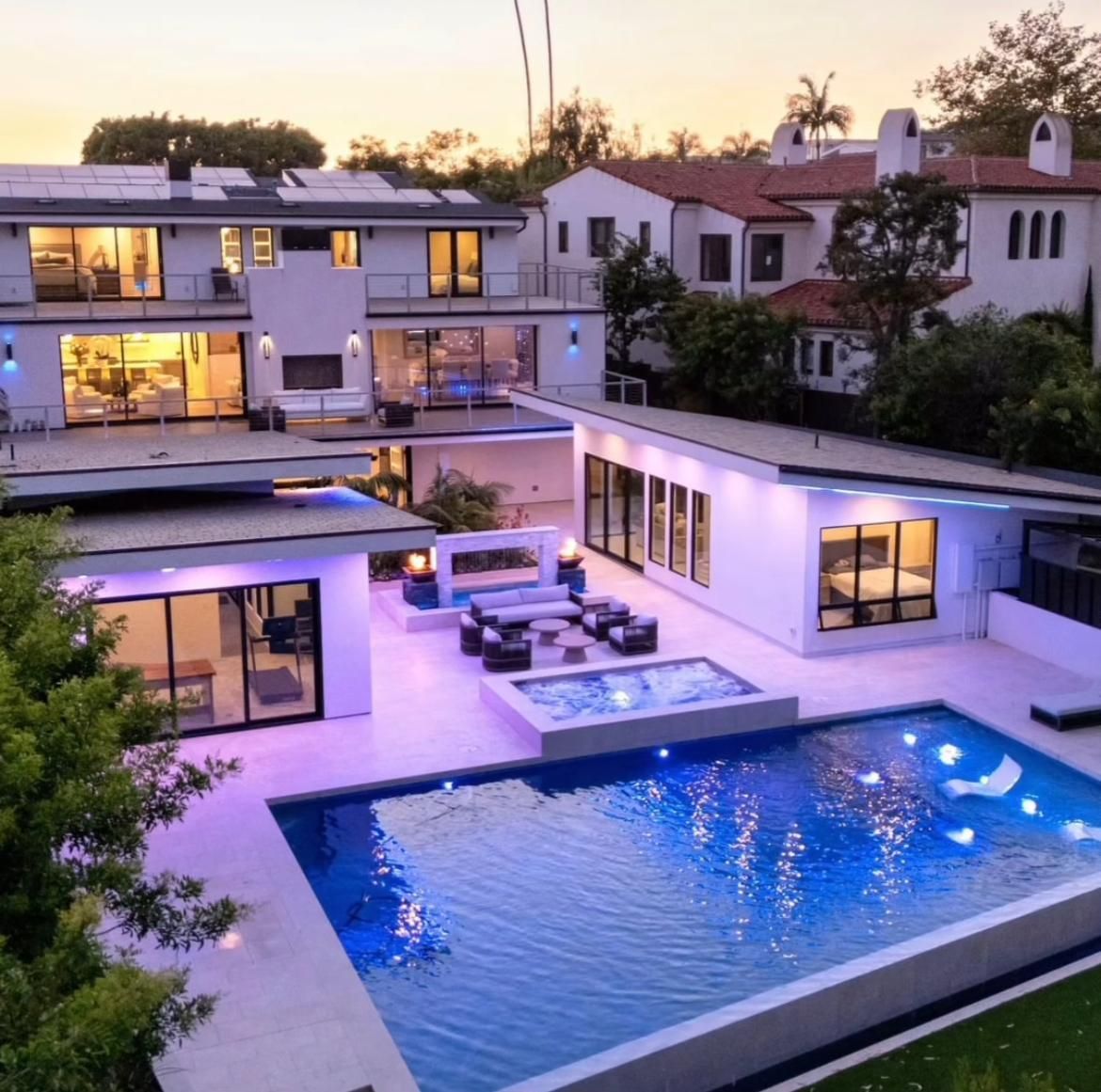 A large house with a large swimming pool in front of it