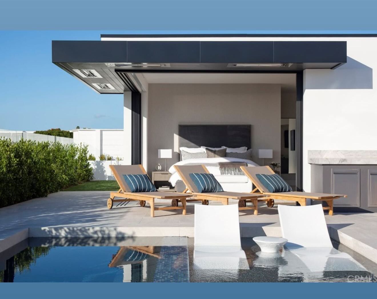 There is a swimming pool in the backyard of a house.