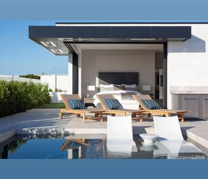 A large swimming pool is in the backyard of a house