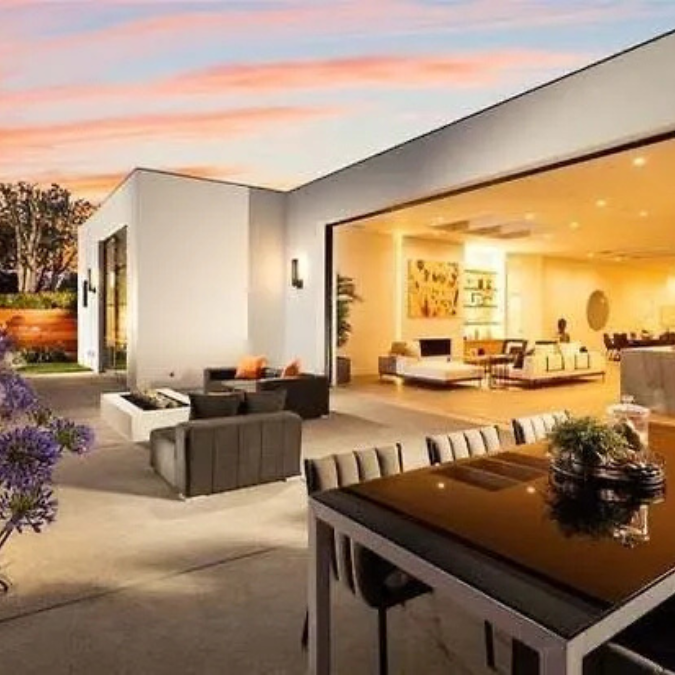 A living room with a table and chairs in front of it