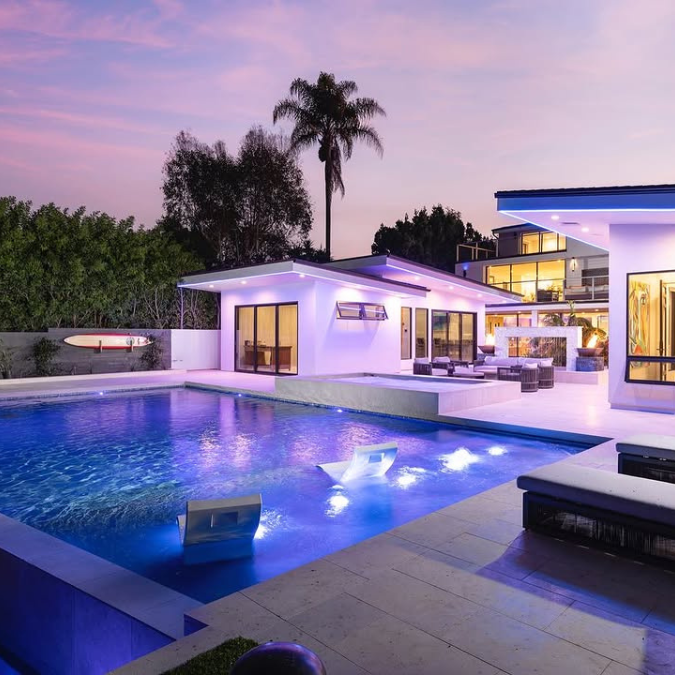A large house with a large swimming pool in front of it