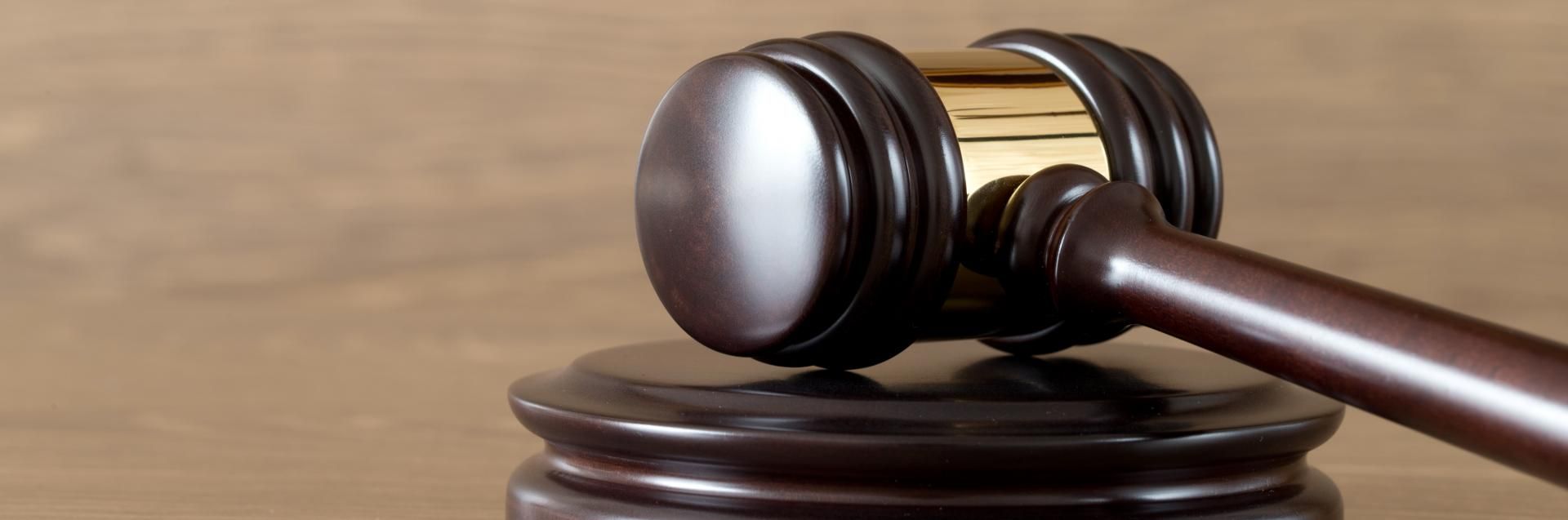 Judge’s gavel resting on a wooden sound block