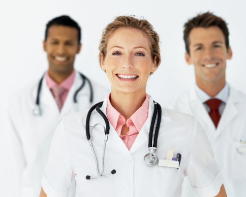 Three smiling doctors in white coats and stethoscopes