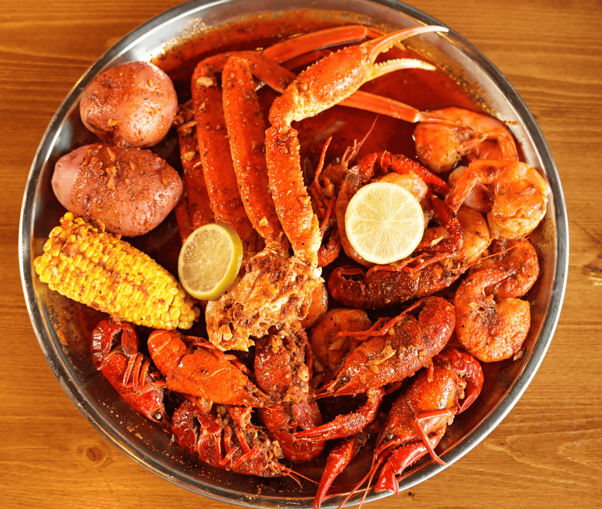 Cajun seafood boil with snow crab legs, shrimp, crawfish, corn, and potatoes at The Juicy Seafood.
