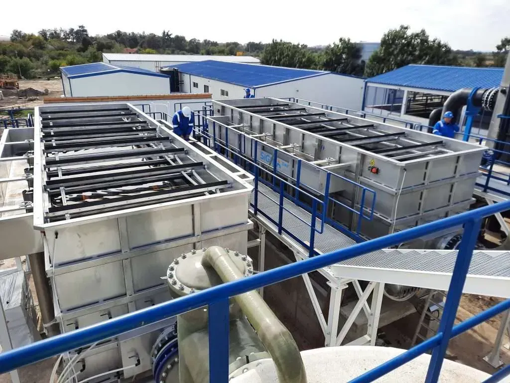 A view of a factory from a balcony with a blue railing.