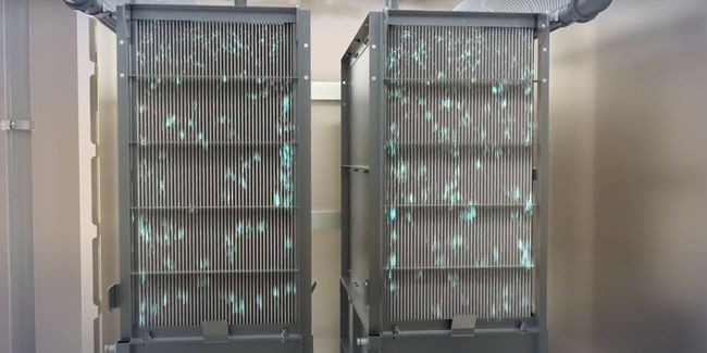 Two server racks are sitting next to each other in a room.