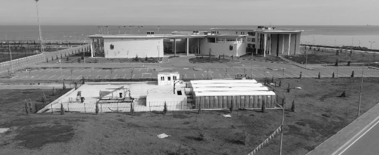 An aerial view of a large building next to the ocean.