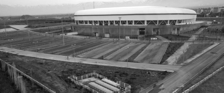 An aerial view of a large building with a lot of parking spaces in front of it.