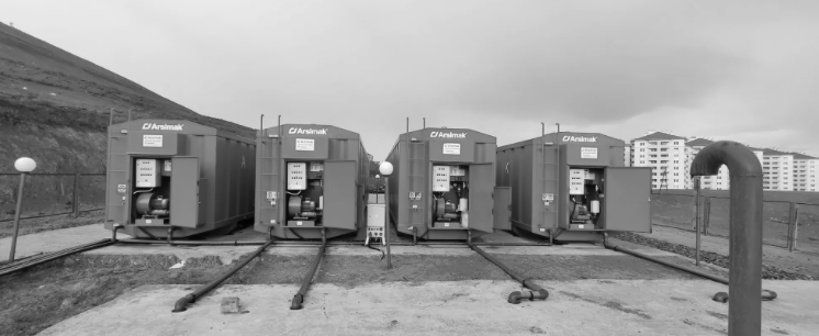 A row of blue containers sitting next to each other in a field.