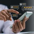 Hand tapping star rating icons on a smartphone screen