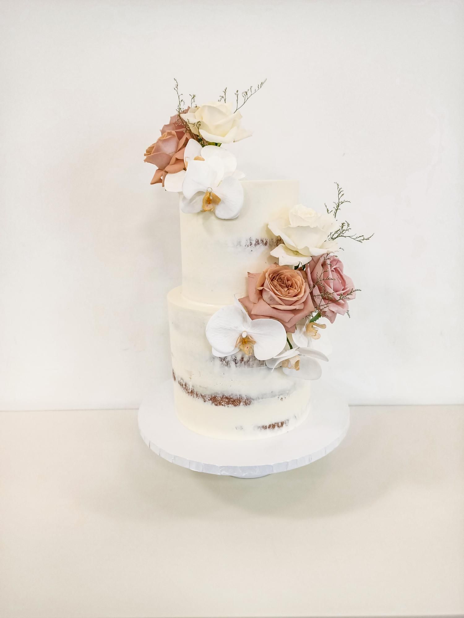 Two tier semi naked wedding cake with elegant flowers Gold Coast
