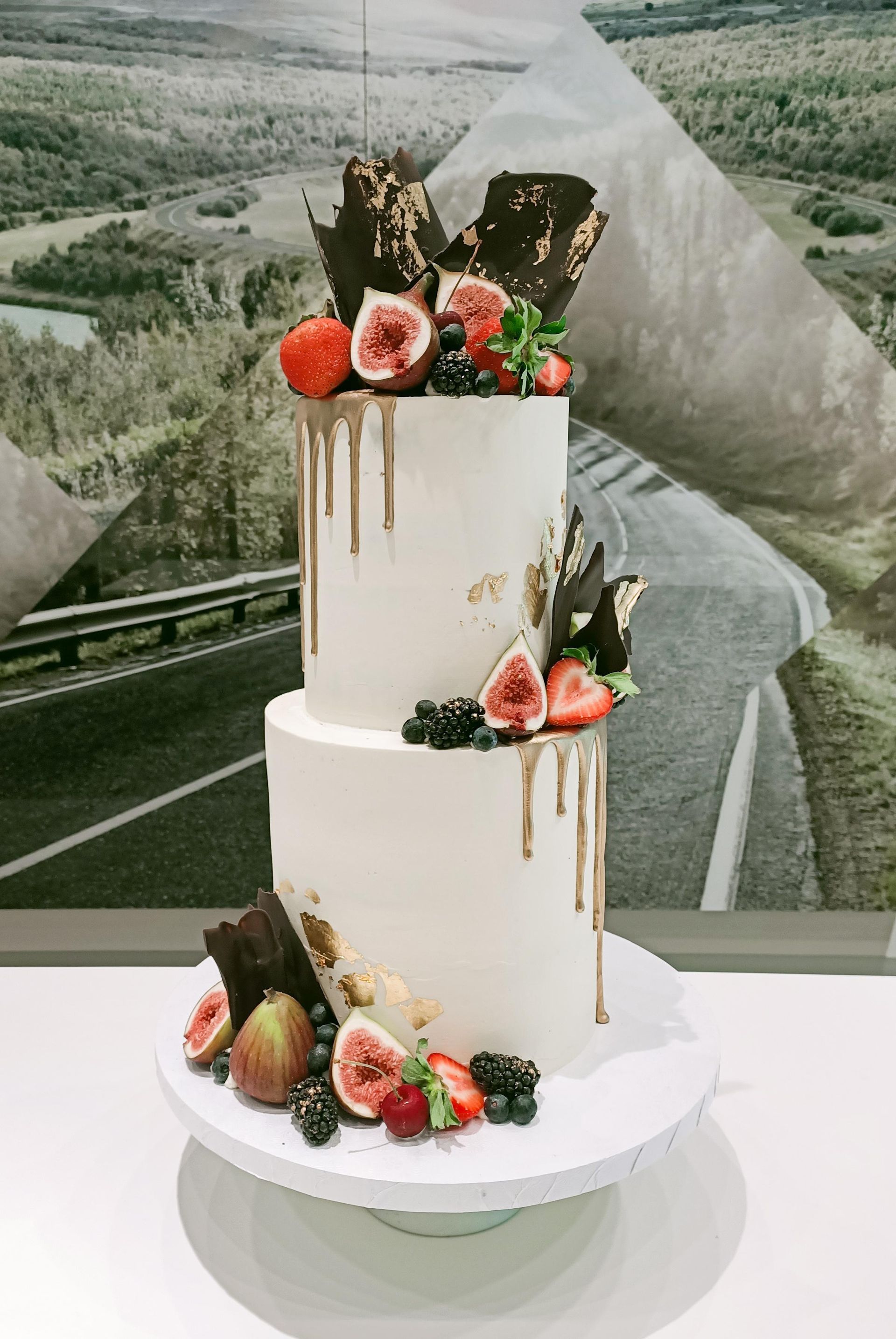 Tiered wedding cake with gold drip and summer berries Gold Coast