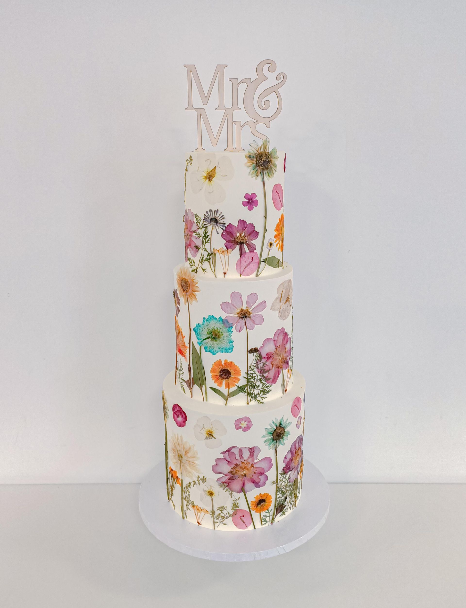 Three tier wedding cake with pressed flowers on the Gold Coast