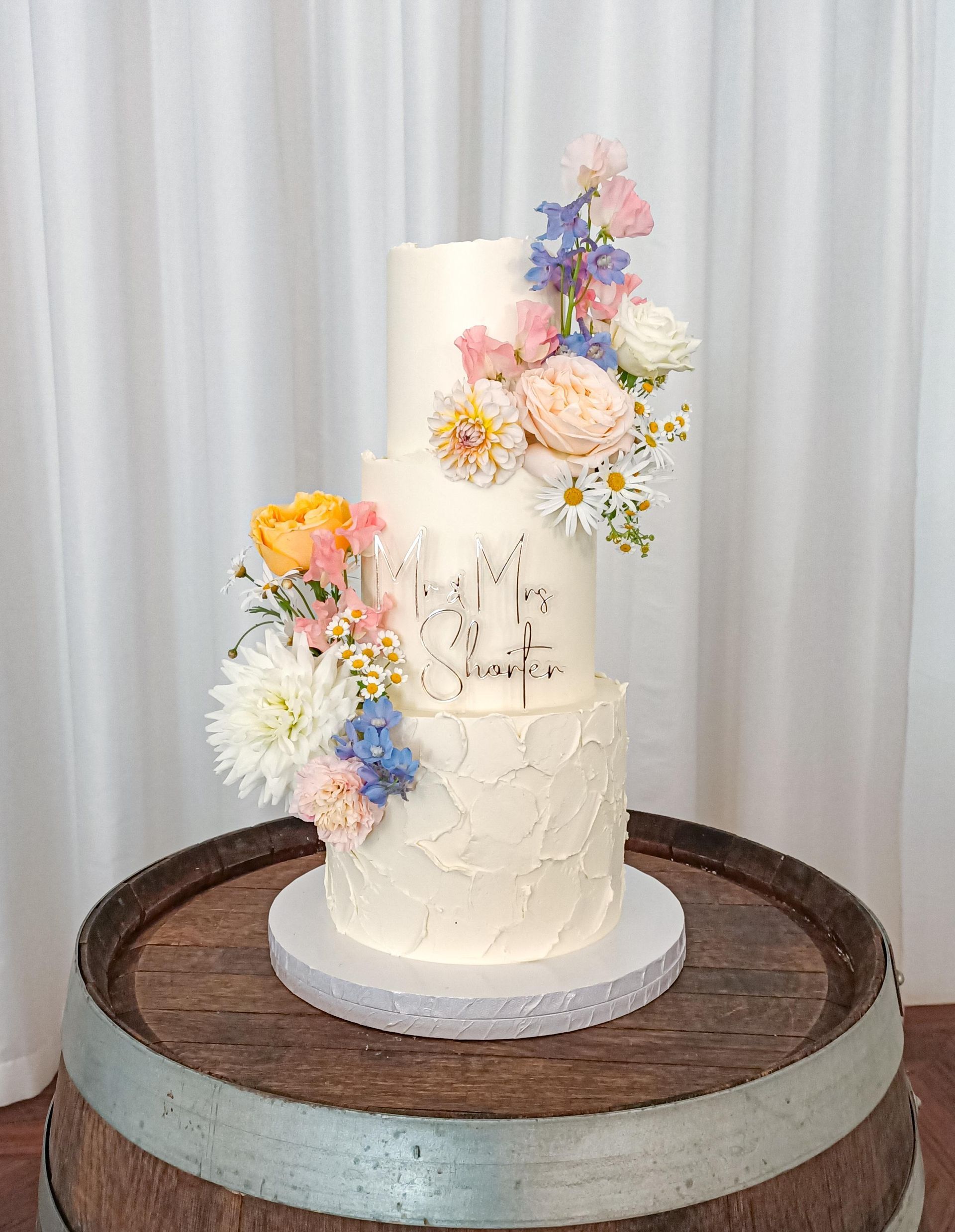 Beautiful textured three tier wedding cake with Spring flowers Gold Coast