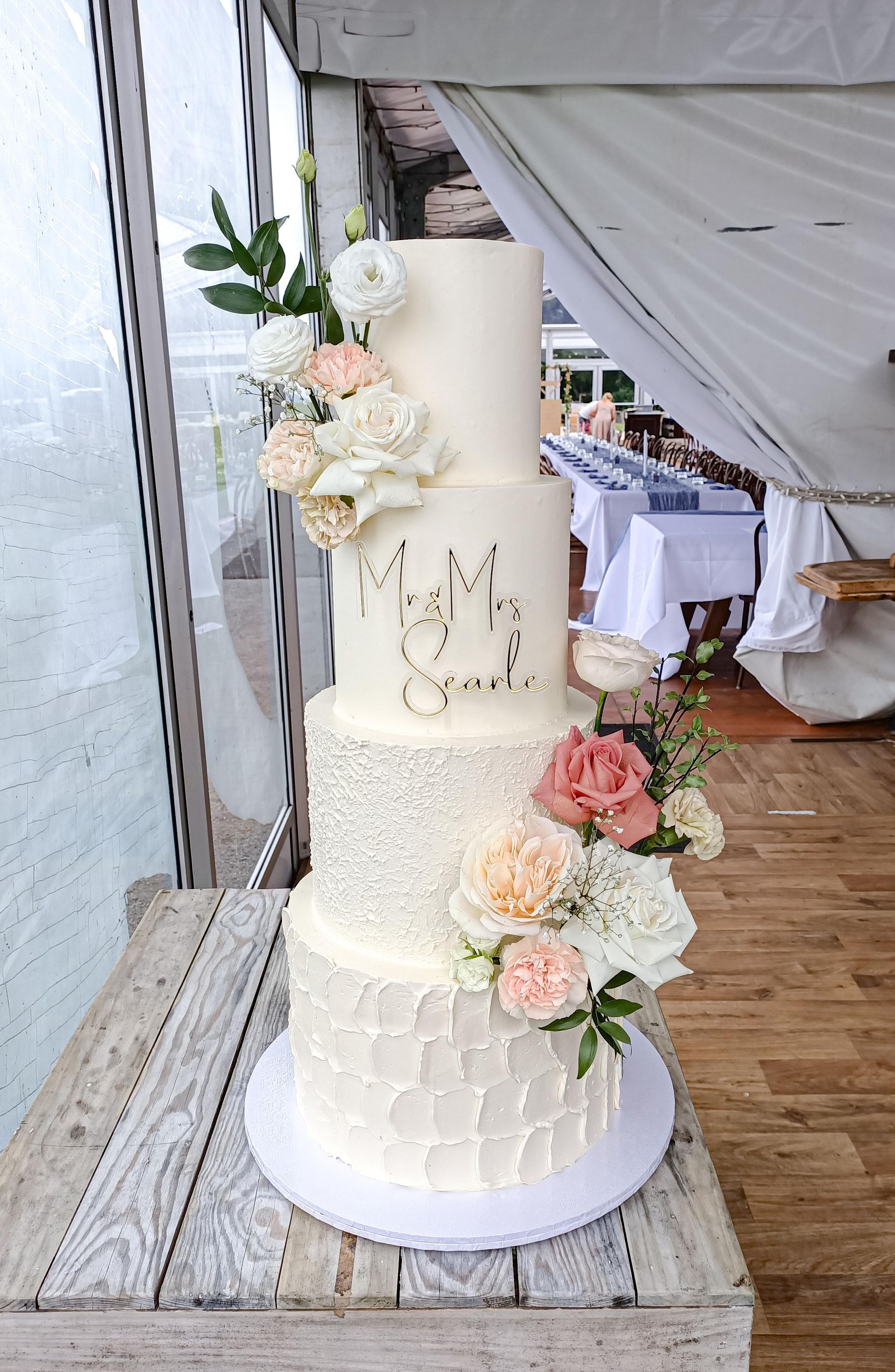 Four tier textured white wedding cake with flowers Gold Coast