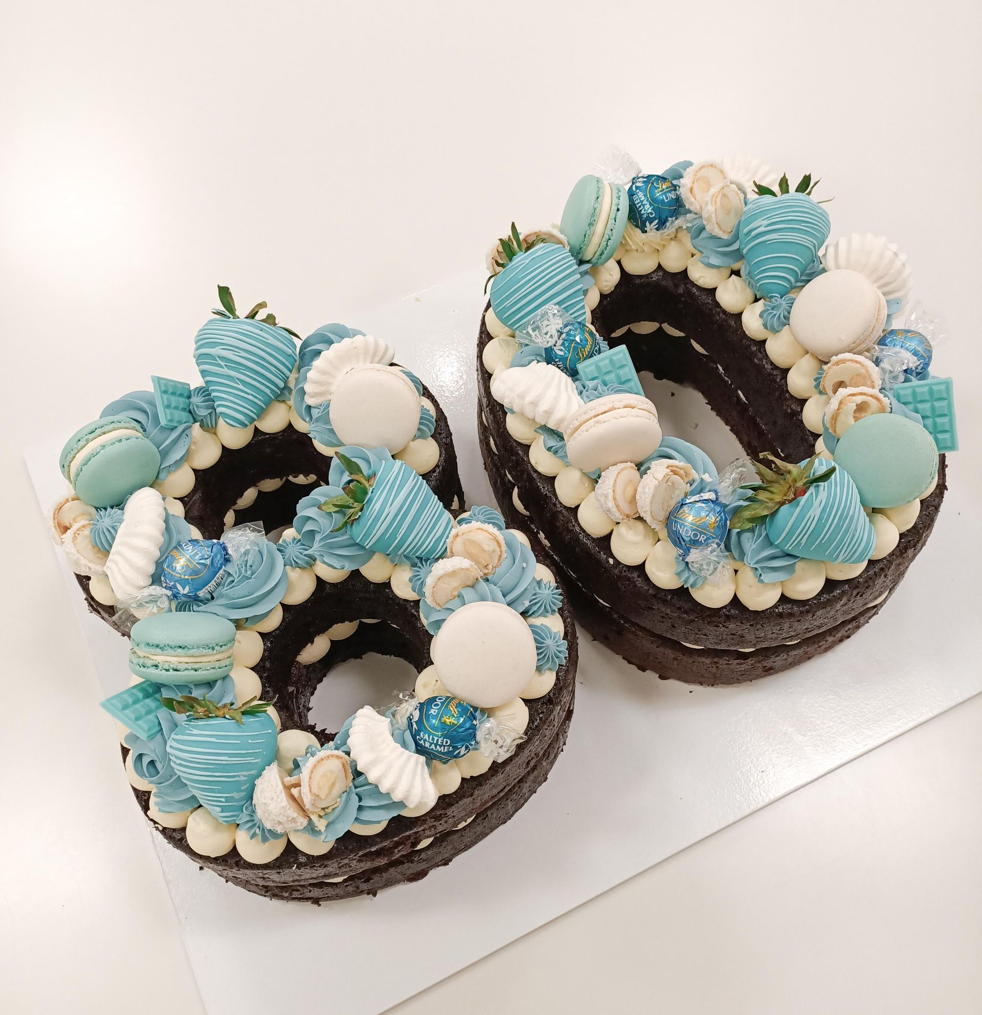 Double number 80 cake with blue and white buttercream and decorations Gold Coast