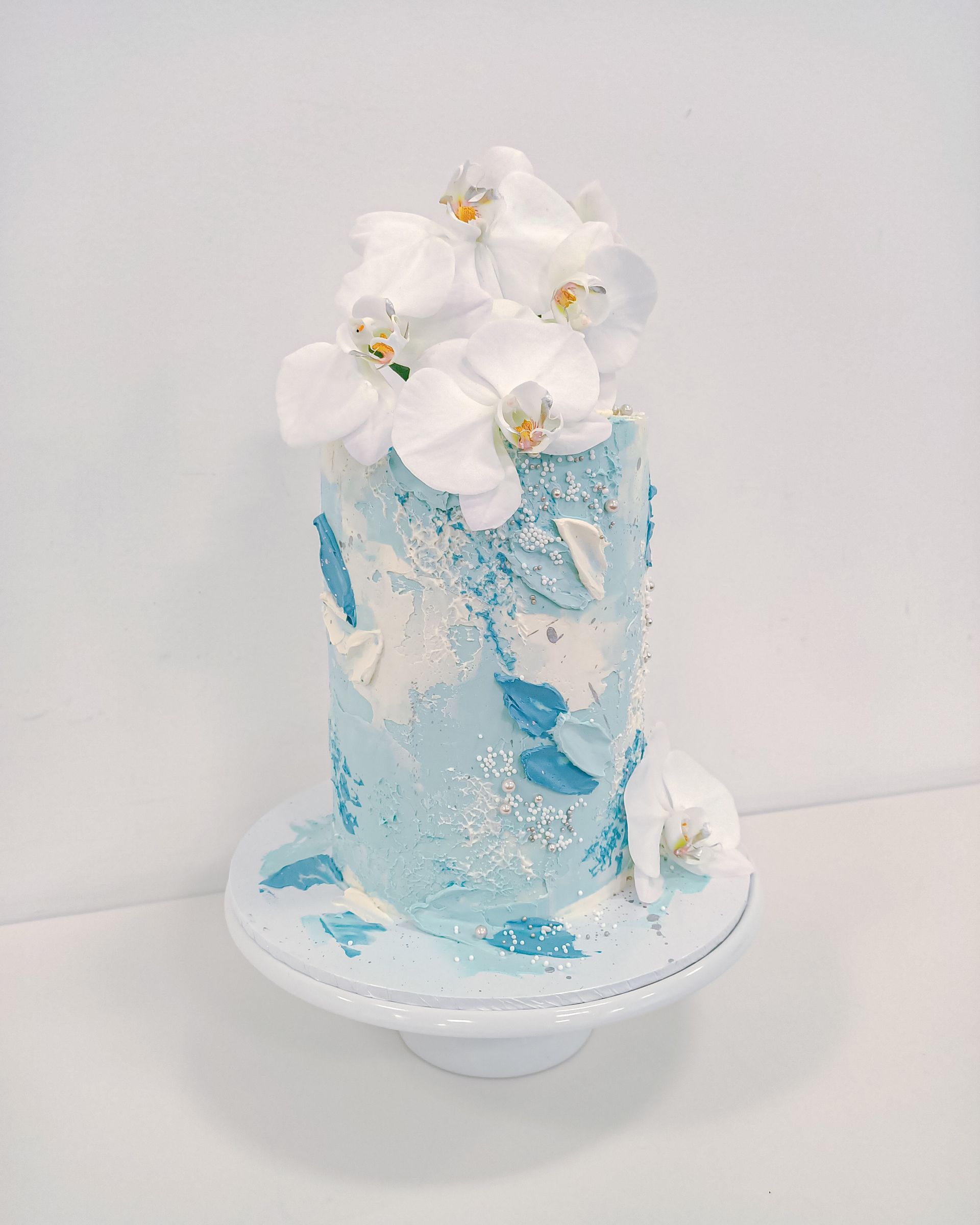 Elegant blue buttercream cake with orchids Gold Coast