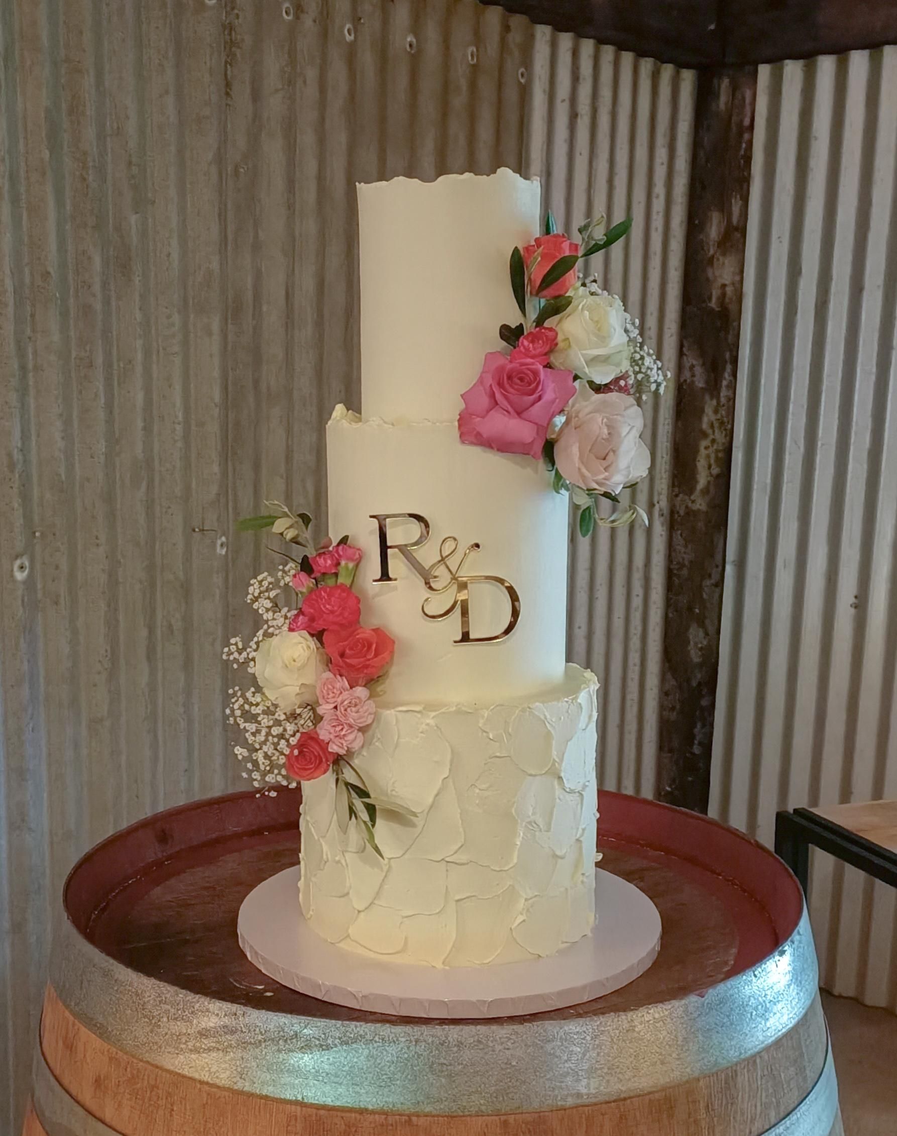 Three tier all white wedding cake with texture and florals Gold Coast