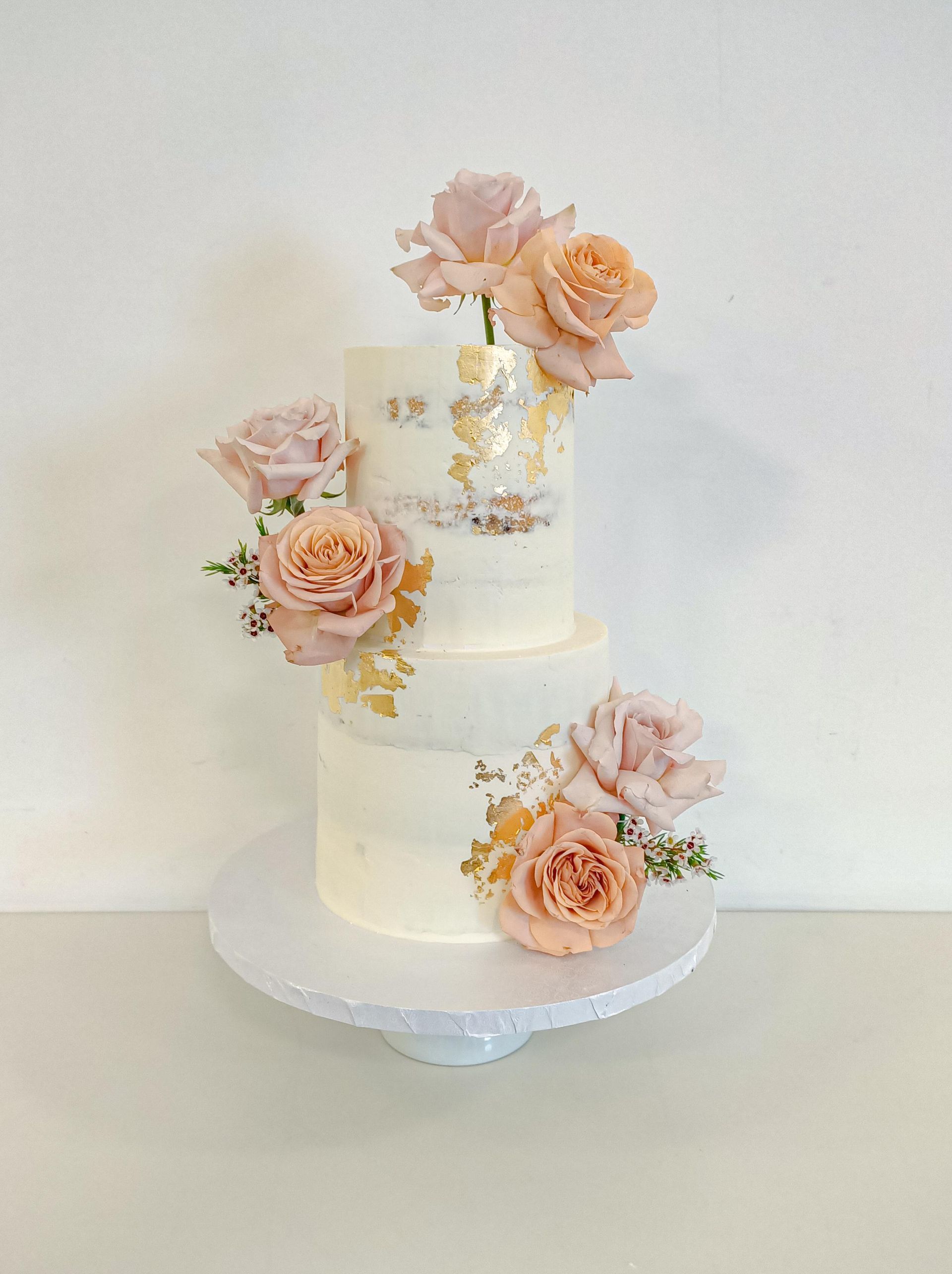 Elegant two tier semi naked wedding cake with flowers Gold Coast