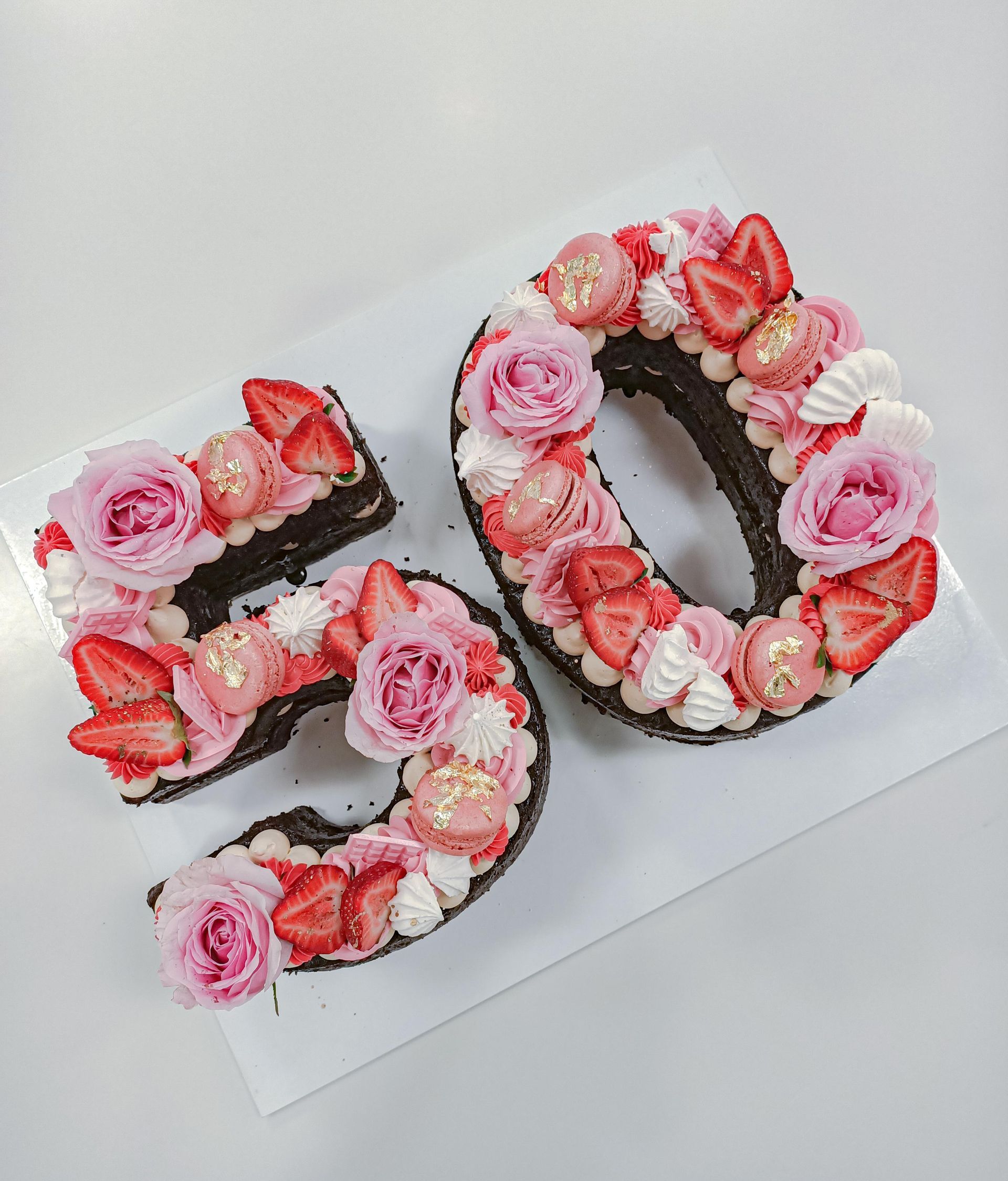 Double number 50 cake with buttercream and decorations in shades of pink Gold Coast