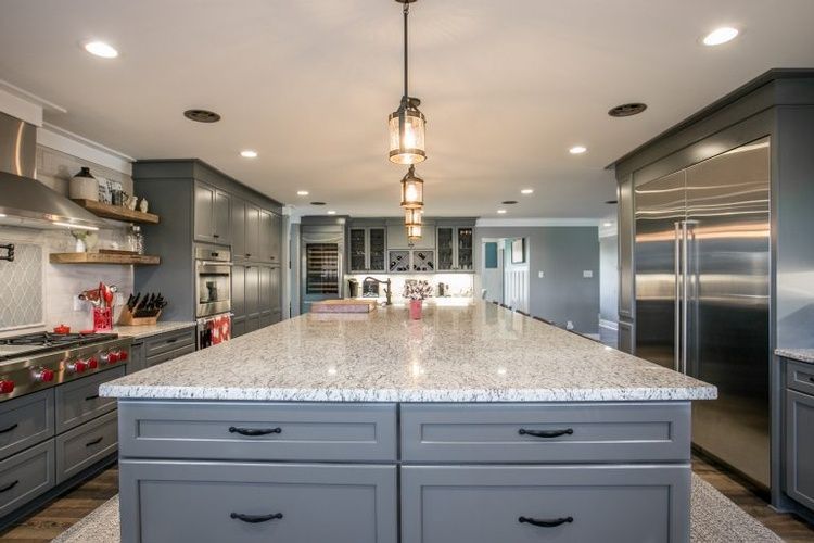 There is a large island in the middle of the kitchen.