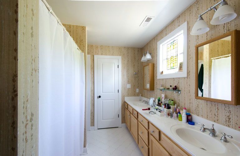 A bathroom with two sinks and a mirror