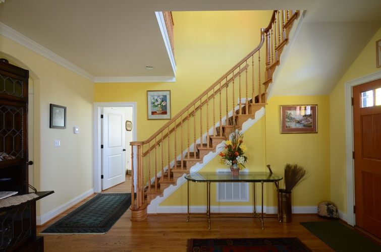 A hallway with a staircase leading up to the second floor