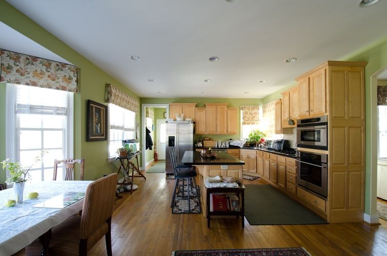 A kitchen with wooden cabinets and stainless steel appliances
