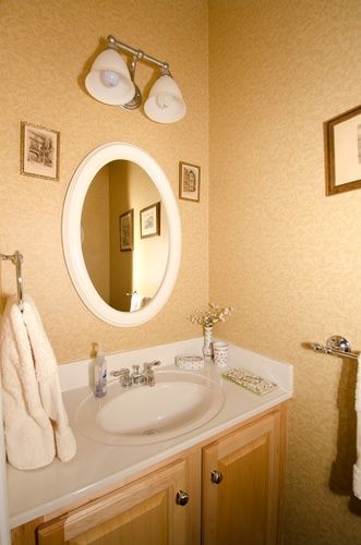 A bathroom with a sink and a mirror on the wall