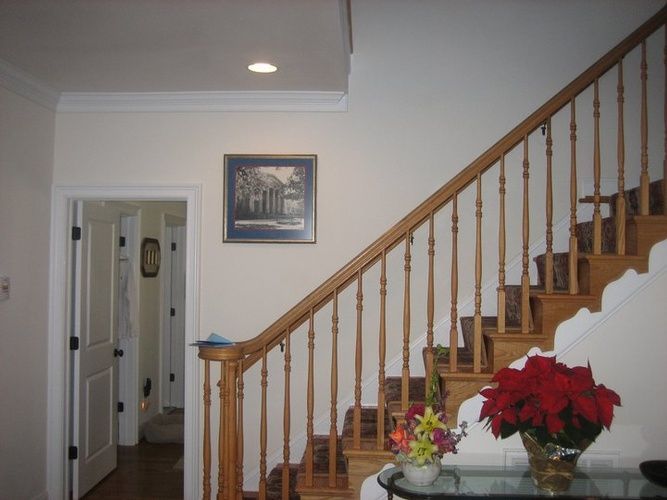 A staircase with a picture on the wall above it