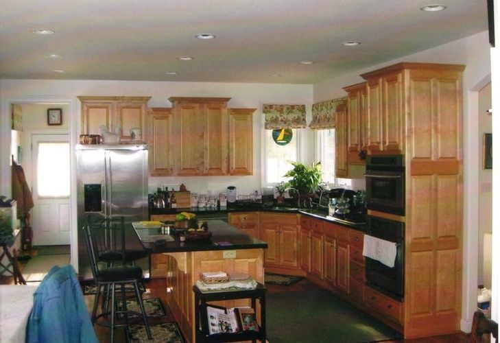 A kitchen with stainless steel appliances and wooden cabinets