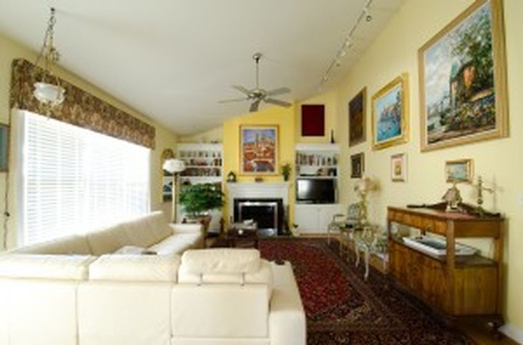 A living room with a white couch and a fireplace