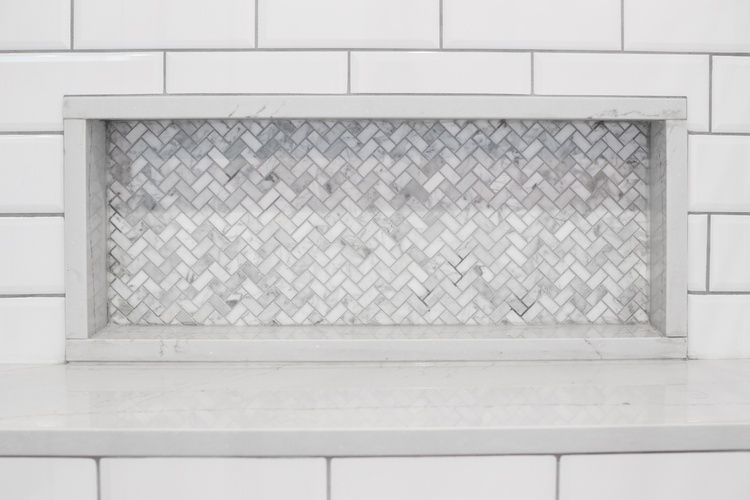 There is a marble tile niche in the wall.
