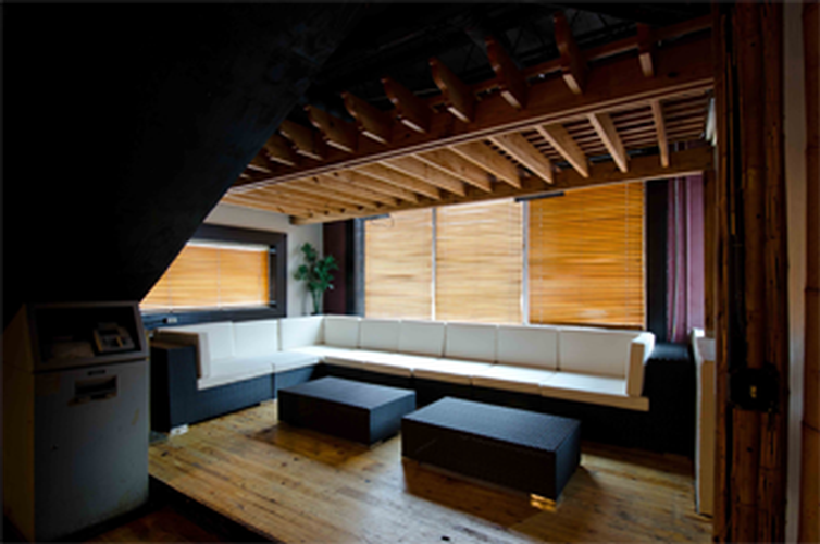 A living room with a couch and two tables