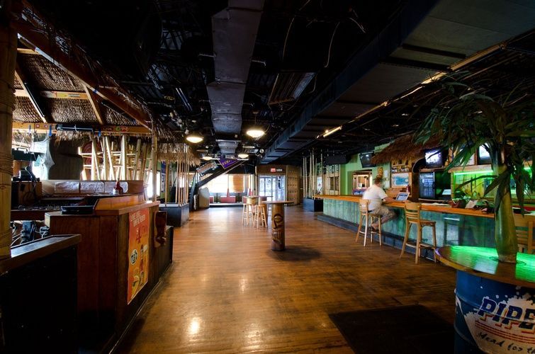 A large room with tables and chairs and a sign that says pipe