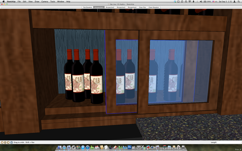 A computer screen shows three bottles of wine on a shelf