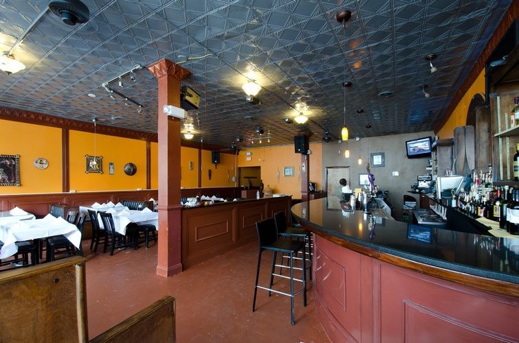 A restaurant with tables and chairs and a bar