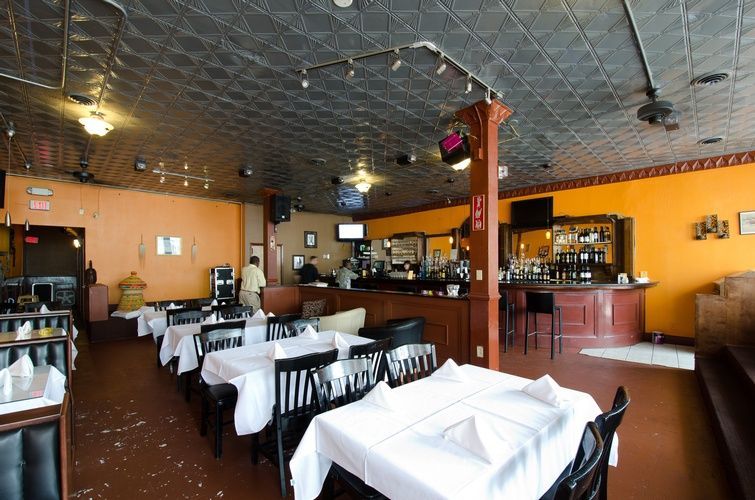 A restaurant with tables and chairs and a bar